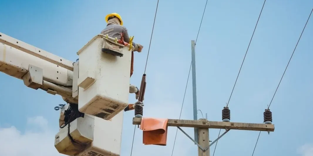 lineman electrical hydro utility lineman working from a truck mounted bucket lift